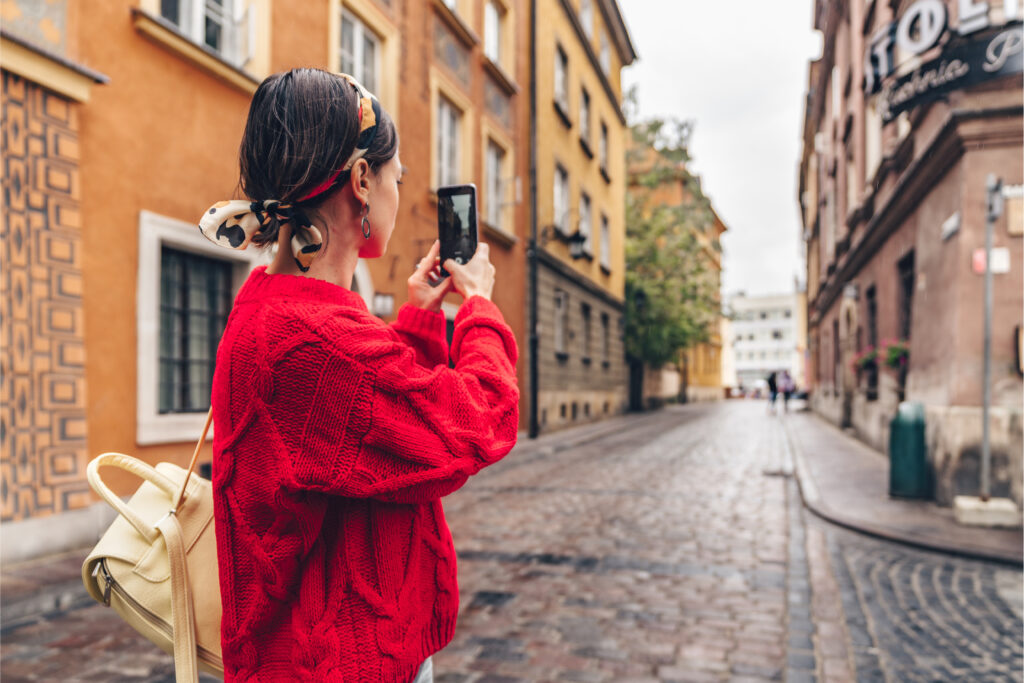 Young traveller taking a photo with her mobile device